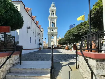 a city street with a clock tower in the background at Alexandros Traditional House in Ialyssos