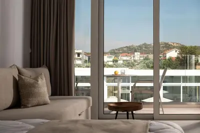 a living room with a couch and a large window at Nama Retreat in Pastida