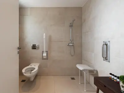 a bathroom with a toilet and a shower and a sink at Nama Retreat in Pastida