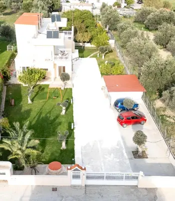 an aerial view of a house with a red car on the driveway at Villa Chelidonia Afantou in Afantou
