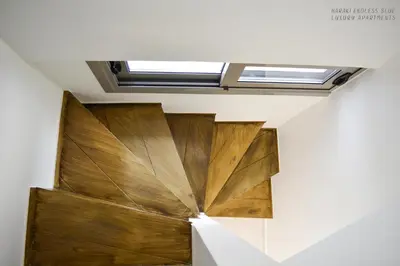 a room with a wooden door and a skylight at Haraki Endless Blue Luxury Apartments in Haraki