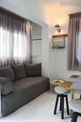 a living room with a couch and a table at Haraki Endless Blue Luxury Apartments in Haraki