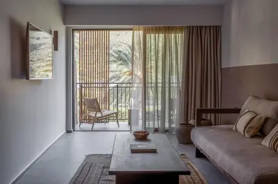 a living room with a couch and a table at Cook's Club Kolymbia Rhodes -Adults only in Kolimbia