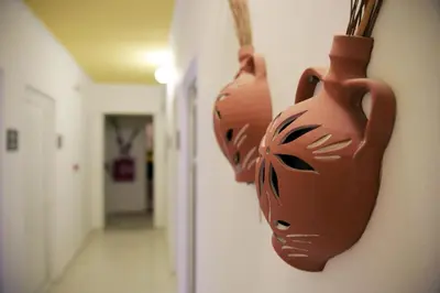 two brown vases are hanging on a wall at Falirala Central in Faliraki