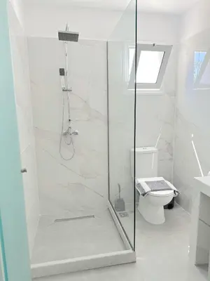a bathroom with a shower and a toilet at Falirala Central in Faliraki