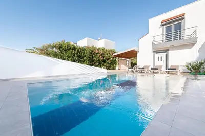 a swimming pool in front of a house at Casa Greco in Gennadi