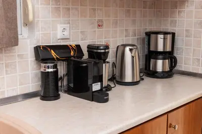 a kitchen counter with three coffins and a coffee maker at Casa Greco in Gennadi
