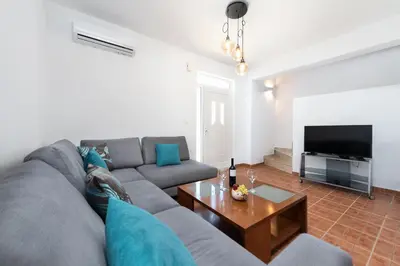 a living room with a gray couch and a table at Casa Greco in Gennadi
