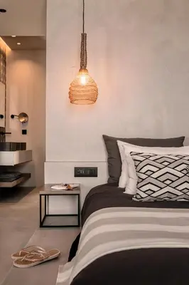 a bedroom with a bed and a pendant light at More Meni City Beach Rhodes in Rhodes Town
