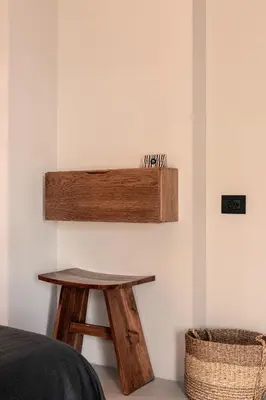 a bedroom with a wooden table and a stool at More Meni City Beach Rhodes in Rhodes Town