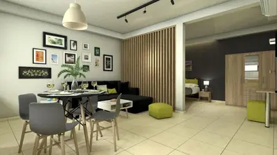 a dining room and living room with a table and chairs at green - comfy center rodos in Asgourou