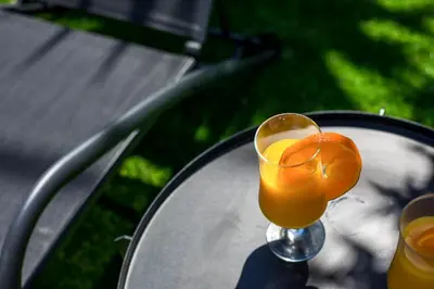 a glass of orange juice sitting on a table at Sunny Villa in Faliraki