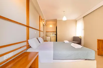 a bedroom with a large bed in a room at Lefka Hotel & Apartments in Rhodes Town