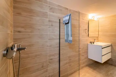 a bathroom with a glass shower and a sink at Lefka Hotel & Apartments in Rhodes Town