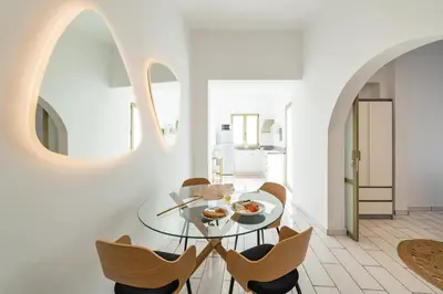a dining room with a glass table and chairs at Lefka Hotel & Apartments in Rhodes Town