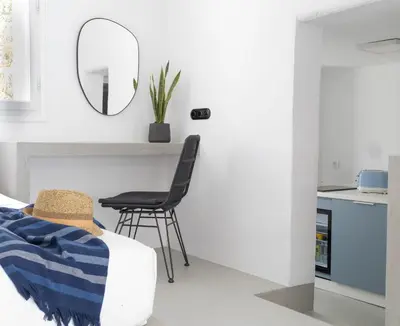 a living room with a chair and a mirror at 30villa Rd Studio in Rhodes Town