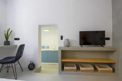 a living room with a television on a shelf at 30villa Rd Studio in Rhodes Town