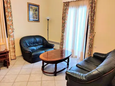 a living room with two leather chairs and a table at Villa Dalia in Archangelos