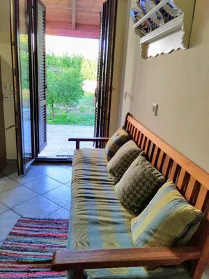 a couch with pillows sitting in a living room at Villa Dalia in Archangelos