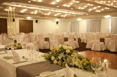 a banquet hall with white tables and white chairs at Port Royal Villas and Spa - Adults Only in Kolimbia