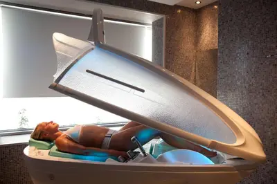 a woman laying in a suitcase with a surfboard at Port Royal Villas and Spa - Adults Only in Kolimbia