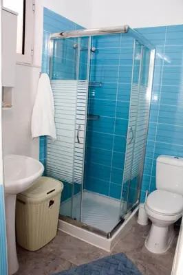 a bathroom with a shower and a toilet and a sink at Marina Beach House in Lardos