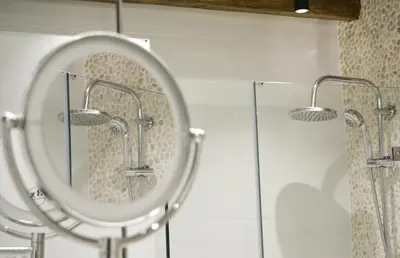 a bathroom with a mirror and glass shower at Haraki Blue Pearl Luxury studio in Haraki