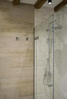 a shower with a glass door in a bathroom at Haraki Blue Pearl Luxury studio in Haraki