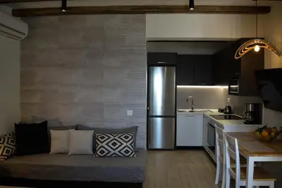 a kitchen and living room with a couch in a room at Haraki Blue Pearl Luxury studio in Haraki