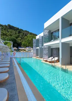 a large swimming pool next to a building at Oceanis Park Hotel in Ixia