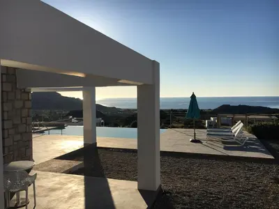a patio with a view of the ocean from a house at Villa in Rhodes near Ladiko Bay in Kalithies