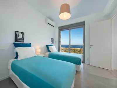 two beds in a bedroom with a view of the ocean at Villa in Rhodes near Ladiko Bay in Kalithies