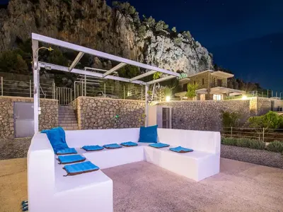 a white couch with blue cushions on a patio at Villa in Rhodes near Ladiko Bay in Kalithies