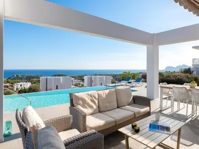 a patio with a couch and chairs and a pool at Villa in Rhodes near Ladiko Bay in Kalithies