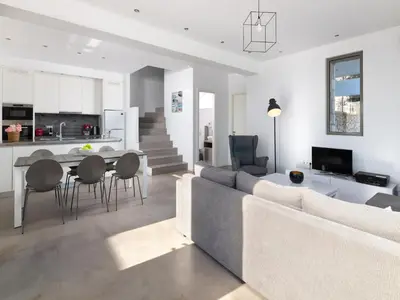 a living room with a couch and a table and chairs at Villa in Rhodes near Ladiko Bay in Kalithies