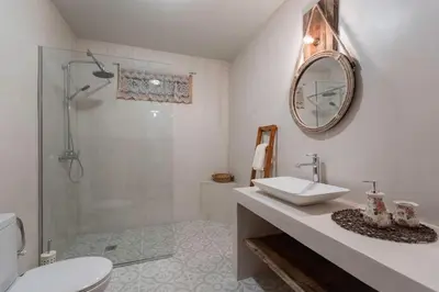 a bathroom with a toilet and a sink and a shower at Rose traditional house in Archangelos