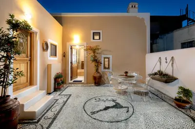 a room with a table and chairs on a floor at Rose traditional house in Archangelos