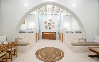 an archway in a room with a table and chairs at Rose traditional house in Archangelos