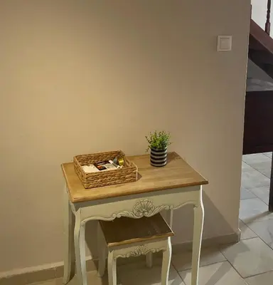 a table with a basket on top of it with a stool at Villa Hiona-Seafront Villa in Halki