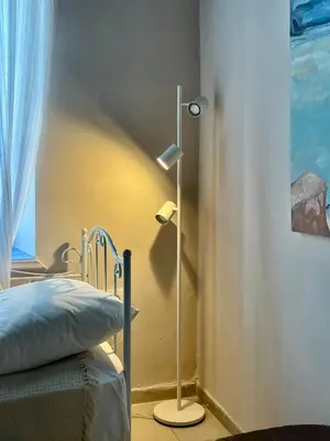 a bedroom with a bed and a lamp next to a window at Villa Hiona-Seafront Villa in Halki