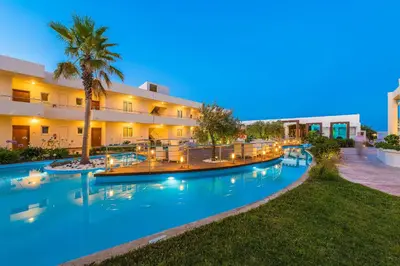 an image of a resort pool at night at Afandou Bay Resort Suites in Afantou