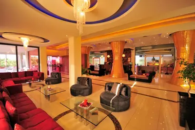 a lobby with couches and chairs in a building at Afandou Bay Resort Suites in Afantou