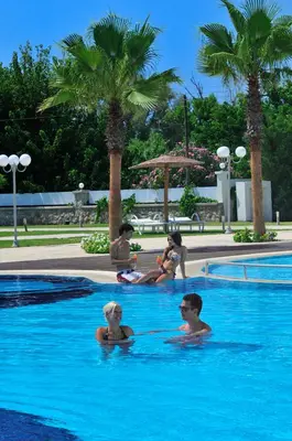 a group of people sitting in a swimming pool at Afandou Bay Resort Suites in Afantou