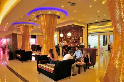 a group of people sitting in the lobby of a hotel at Afandou Bay Resort Suites in Afantou