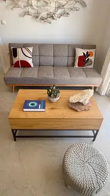 a coffee table in a living room with a couch at Euphoria Luxury apartment in Faliraki