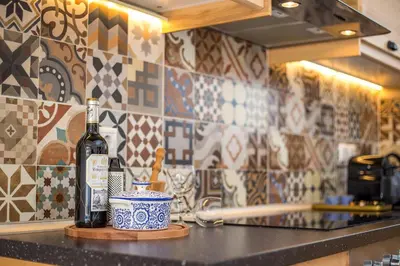 a bottle of wine sitting on a counter in a kitchen at Euphoria Luxury apartment in Faliraki