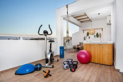 a room with a gym with exercise equipment on the floor at Euphoria Luxury apartment in Faliraki