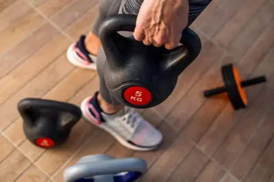 a person is holding a dumbbell in a gym at Euphoria Luxury apartment in Faliraki