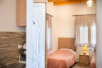 a small bedroom with a bed and a window at Vista Mare in Archangelos