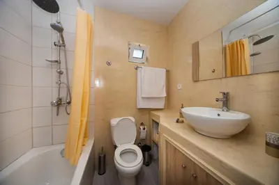 a bathroom with a sink and a toilet and a tub at Vista Mare in Archangelos
